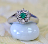 Emerald Center Surrounded by Diamonds Ring